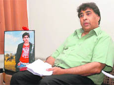KS Anand, father of Rahul Anand, who was killed in a road mishap, addresses a press conference in Gurgaon on Sunday. Also seen in the picture is his late sons photograph.