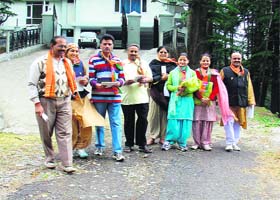 BJP workers campaign for party candidate Varinder Kashyap at Jakhu in Shimla