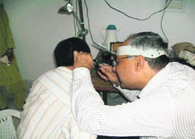 Director, Fortis, Delhi, Dr Sanjay Sachdeva examines a patient during a camp organised in Kangra