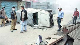 A security vehicle overturns after it was attacked by stone-pelting youths in Srinagar on Sunday