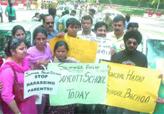 Parents of the students of Summer Fields School, Kailash Colony, protest outside the residence of AICC president Sonia Gandhi at 10 Janpath against fee hike by private schools, on Monday.