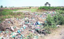 A view of garbage dumped at the cremation ground in Puro Bana village of RS Pura.