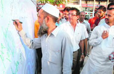 Residents take part in a signature campaign in Chandigarh on Tuesday.