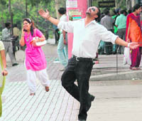 A man enjoys the shower in Sector 17, Chandigarh, on Tuesday.