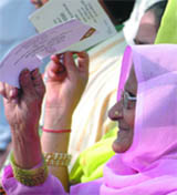 An elderly woman listens to AICC general secretary Rahul Gandhi during an election rally at Seelampur in East Delhi