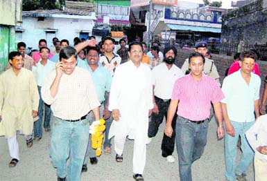 Congress workers on a door-to-door campaign in Dehradun on Tuesday.