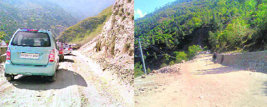 Vehicles cross a dangerous road curve in the apple belt of Shimla; and  the Bali-Banjar-Ani road which is in bad shape.