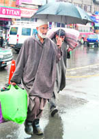 Carrying on with normal routine on a rainy day in Srinagar on Tuesday.