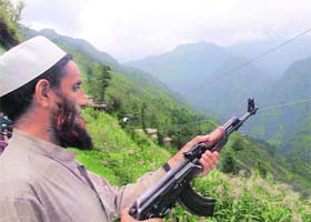 A member of the village defence committee keeps a vigil in Marah village in the Hill Kaka area of Surankote