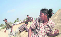 Sri Lankan ethnic Tamil civilian trapped in Tiger-controlled war zone take cover from shell firing in Mullivaikl in Sri Lanka