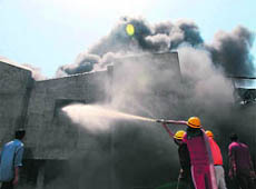 Firefighters try to put out fire at an industrial unit in Gurgaon on Wednesday.