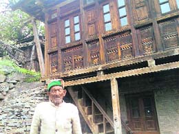 Shayam Charan in front of his house.