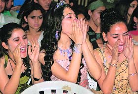 Girls cheer participants during a fashion show organised by Sat Guru Ram Singh Polytechnic for Women, Ludhiana