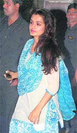 Bollywood actor Amisha Patel in a white and turquiose salwar kameez. 