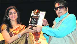Veteran Bollywood actor-director Manoj Kumar receives the Phalke Golden Singer Award from actor Sridevi Kapoor on the occasion of 140th birth anniversary of Dadasaheb Phalke in Mumbai 