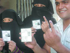  Muslim voters show their voter ID cards after casting their votes at a polling station in the Old Delhi area on Thursday. 