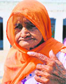 Mansa Devi (104) shows her indelible ink mark after casting vote at a polling booth in Garhi Birbal in Karnal district on Thursday.