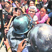 The police try to stop Maoist protesters from reaching President Ram Baran Yadavs office in Kathmandu on Thursday.