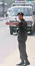 A Sri Lankan soldier stops vehicles at a roadside check point in Colombo on Thursday.