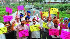 UP In Arms: Residents of Medical Enclave near Ganda Nallah raise slogans against the government duirng a protest march in Amritsar.