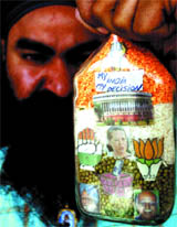 An Amritsar resident displays his art piece to inspire people to vote.