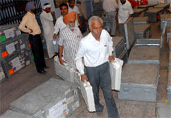 Officials carry electronic voting machines (EVMs) brought from various parts of the Bathinda parliamentary constituency to be stored at a college in Bathinda on Friday morning.