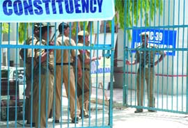 Security personnel guard a school where electronic voting machines have been kept in New Delhi on Friday.