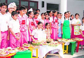 Students of Peace Public School display salads made by them on Mother’s Day in Mullanpur Dhaka on Friday.