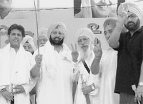 Former Chief Minister Captain Amarinder Singh brandishes a sword during a Congress rally at Latala village, Ludhiana, on Friday.