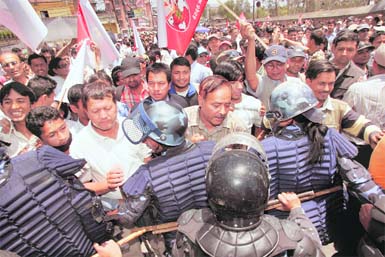 Maoist supporters try to break the police barricade and enter President Ram Baran Yadavs office in Kathmandu on Friday. 
