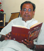 BJP West Delhi candidate Jagdish Mukhi reads a book at his residence.