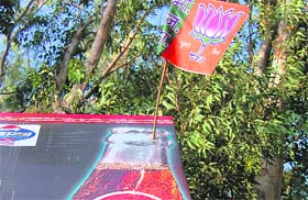 A BJP flag atop a Pepsi hoarding in Dehradun
