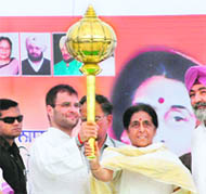 Congress general secretary Rahul Gandhi holds up a mace with party candidate Santosh Chaudhary in Hoshiarpur on Saturday.