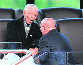 South African President Jacob Zuma (right) talks to Nelson Mandela during the swearing-in ceremony at the Union Buildings in Pretoria on Saturday.