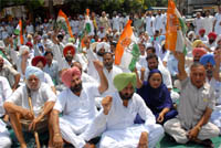 Congress workers, led by Narinder Singh Bhaleria, district president (rural) and Tehal Singh Sandhu, secretary, PPCC, staging protest outside the Sadar police station in Bathinda on Sunday.