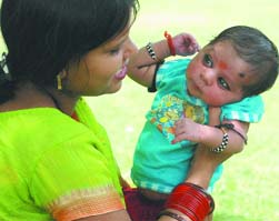 21-day-old Sanket enjoys with his mother at the India Gate lawn in New Delhi on Sunday.