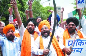 Activists of the National Akali Dal shout anti-Pakistan government slogans during a protest against the jazia levied on Pakistani Sikhs and Hindus by Taliban, in New Delhi on Sunday