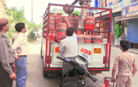LPG consumers collect cylinders as the IOC has suspended the home delivery in Palampur.