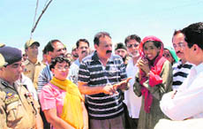 Labour and Employment Minister Surjeet Singh Salathia interacts with aggrieved Gujjar families in Belicharana on Sunday.
