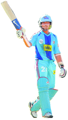 Ajinkya Rahane of Mumbai Indians raises his bat to celebrate his half century during their match against Royal Challengers at St. Georges cricket stadium in Port Elizabeth on Sunday.