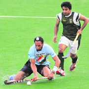 India's Sardar Singh (L) pushes the ball away from Pakistans Waseen Ahmed during their Men's Asia Cup hockey match in Kuantan on Sunday.