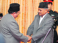 Nepals President Ram Baran Yadav (rigt) shakes hands with newly appointed Chief Justice Min Bahadur Rayamajhi at his oath-taking ceremony at the President House in Kathmandu on Sunday.