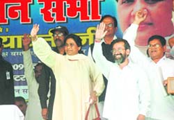 BSP supremo Mayawati along with partys Haridwar candidate Munna Singh Chauhan (R) wave to the crowd 