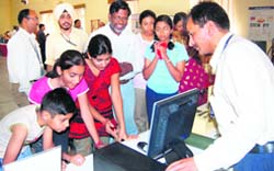 Students take a look at defence equipment at the IRDE exhibition on the National Technology Day in Dehradun