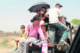 A three-wheeler on the Gurgaon-Mewat road carries passengers more than its capacity.