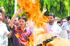Members of the University Students and Scholars Union burn an effigy of the administration to protest the police action against the Gujjars during a demonstration in Jammu on Monday.