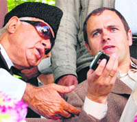 CM Omar Abdullah shares a point with his father Dr Farooq Abdullah during an election rally at Handwara on Monday.
