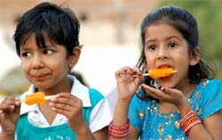 On a hot Tuesday afternoon, children eat ice-candies to get some relief from the heat. The temperature in the city is hovering around 40 degrees Celsius. 