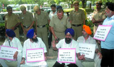 Activists of the Shiromani Akali Dal (Badal) protest against Prime Minister Manmohan Singh for his statement that Sikhs should forget the 1984 riots, outside his residence in New Delhi on Tuesday.