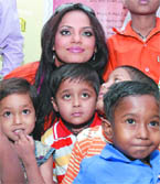 Actor Neetu Chandra poses with children suffering from serious ailments during a function organised by the Gitanjali Group in New Delhi on Tuesday.